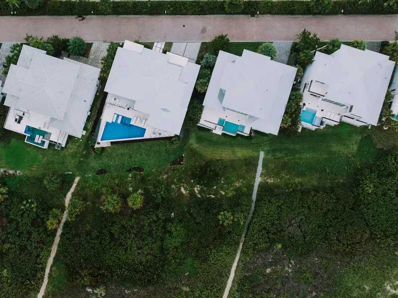 Plumber in Doral: modern homes with pools seen from above