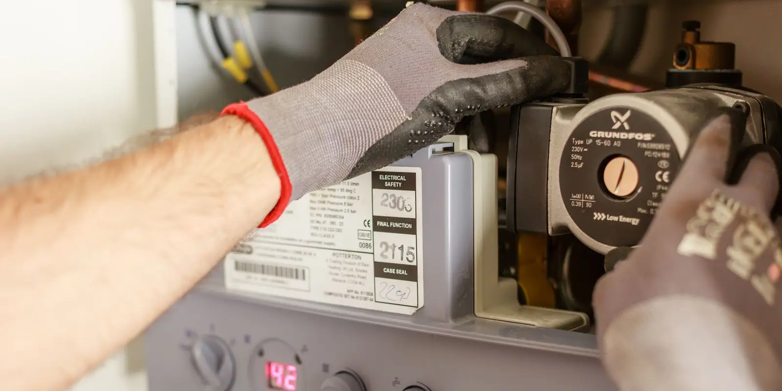 Water heater repair in Miami: hands adjusting heater controls